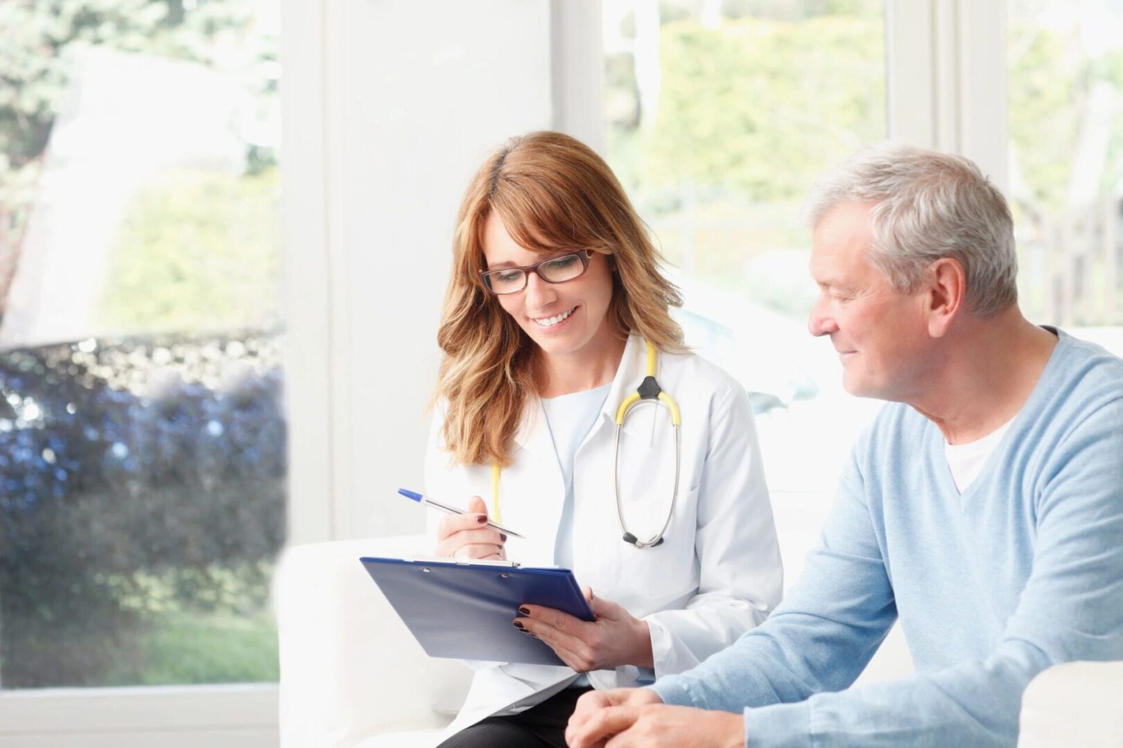 A doctor and patient smiling at each other.