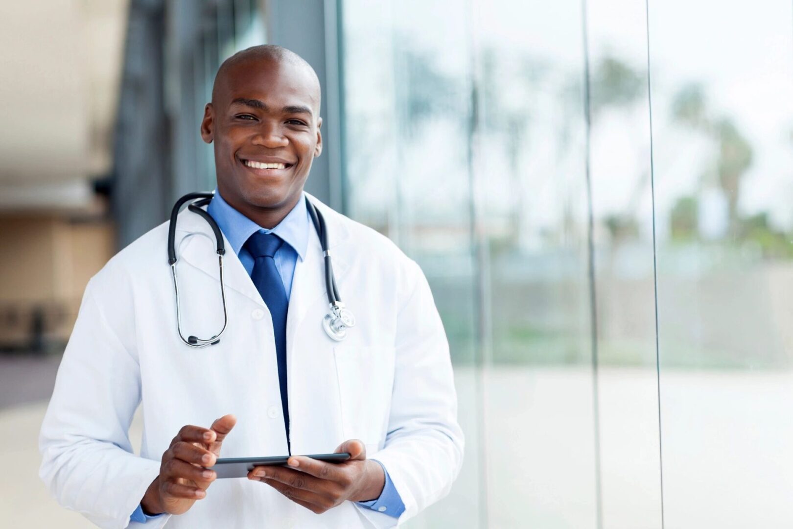 A doctor holding a tablet in his hands.