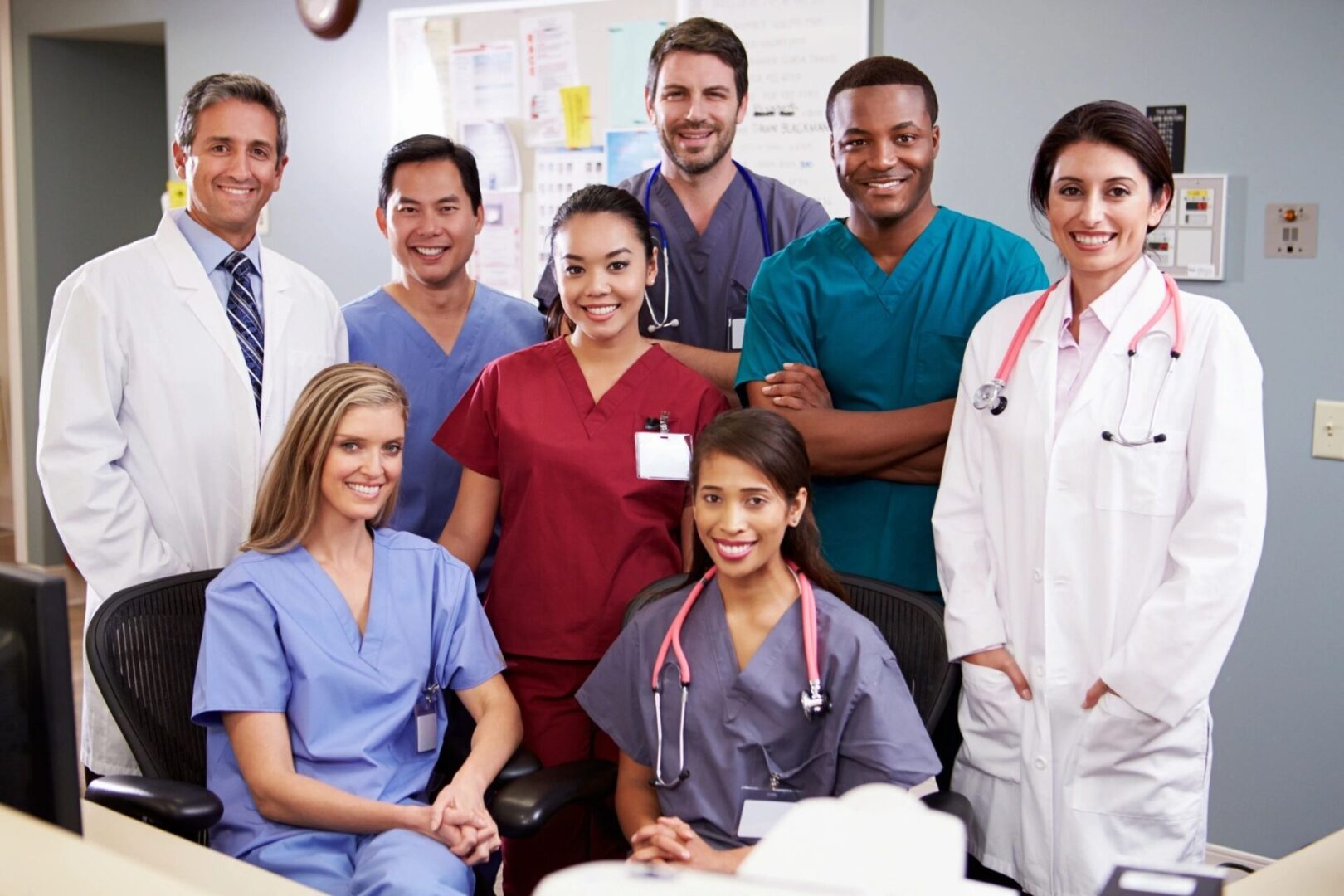 A group of doctors and nurses posing for the camera.